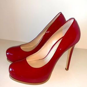 Woman’s red patent leather shoe